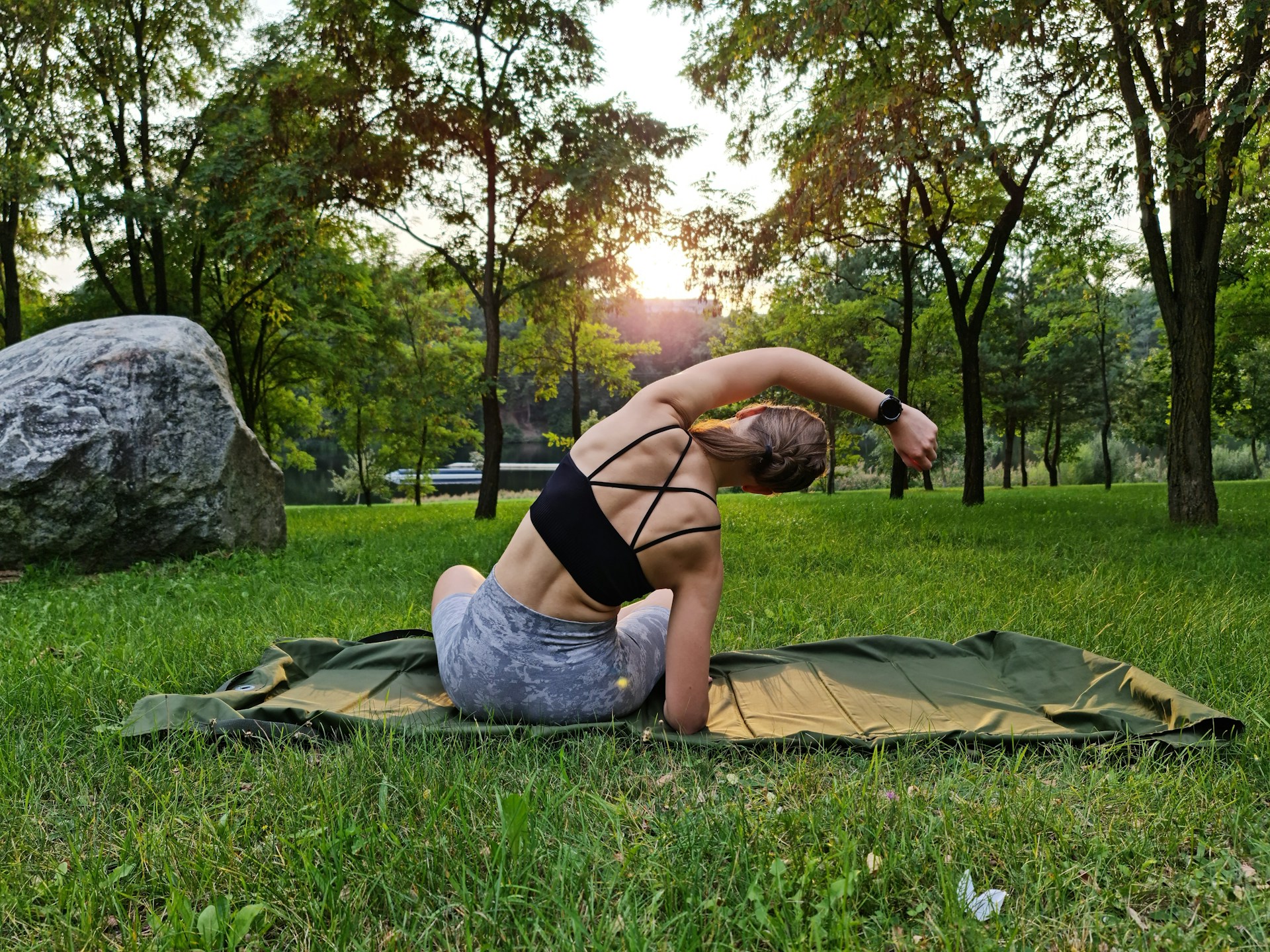 Woman stretching outdoors at sunset